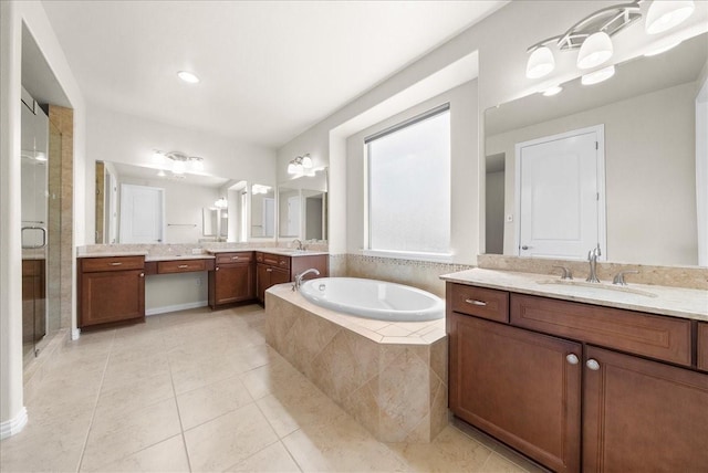 full bath with a sink, a shower stall, a bath, and tile patterned floors