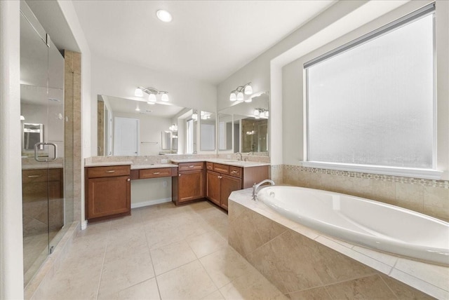 bathroom featuring a stall shower, tile patterned flooring, vanity, and a bath