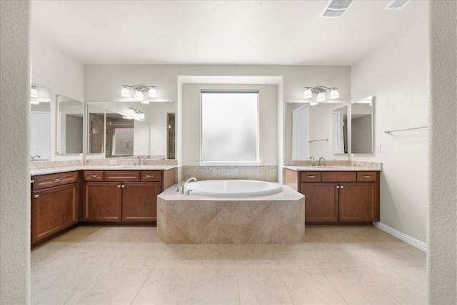 bathroom with two vanities, a sink, a bath, and tile patterned floors