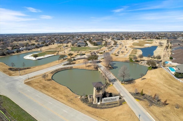 drone / aerial view featuring a water view and a residential view