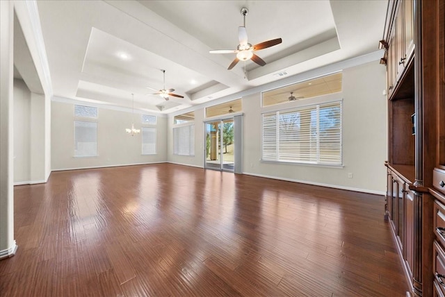 unfurnished living room with dark wood-type flooring, a tray ceiling, baseboards, and ceiling fan with notable chandelier