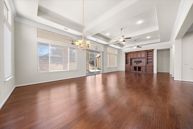 unfurnished living room with a tray ceiling, a glass covered fireplace, and dark wood finished floors