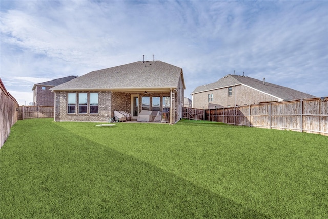 rear view of house featuring a yard and a patio area