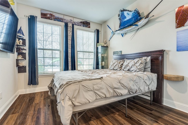 bedroom with dark wood-type flooring