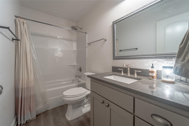 full bathroom with vanity, hardwood / wood-style floors, shower / bath combination with curtain, and toilet