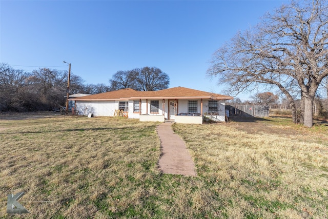 ranch-style house with a front yard and a porch