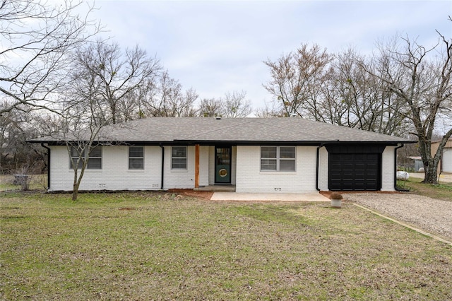 ranch-style home with a garage and a front yard