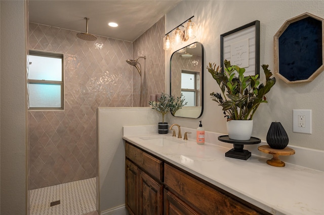 bathroom featuring vanity and a tile shower