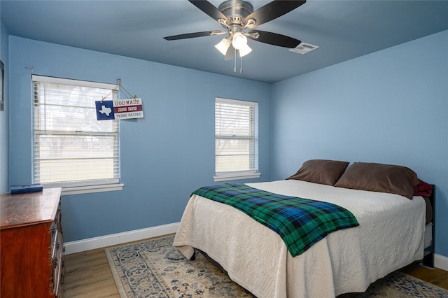 bedroom with ceiling fan and wood-type flooring