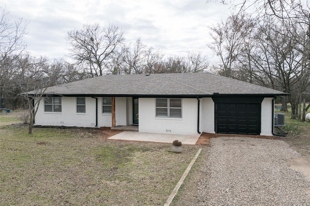 ranch-style house featuring a garage, a patio area, a front lawn, and central air condition unit