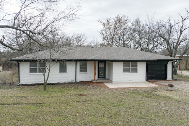 ranch-style house with a garage and a front lawn