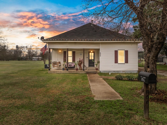 bungalow with a yard and a porch