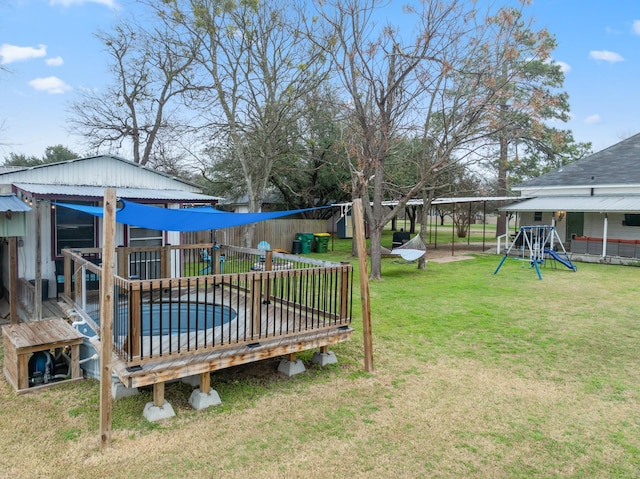 view of yard with a playground and a swimming pool side deck