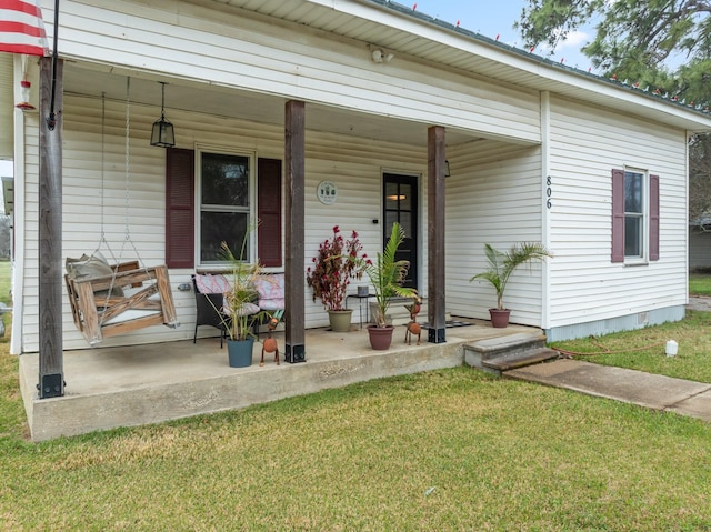 view of front of home with a porch and a front lawn