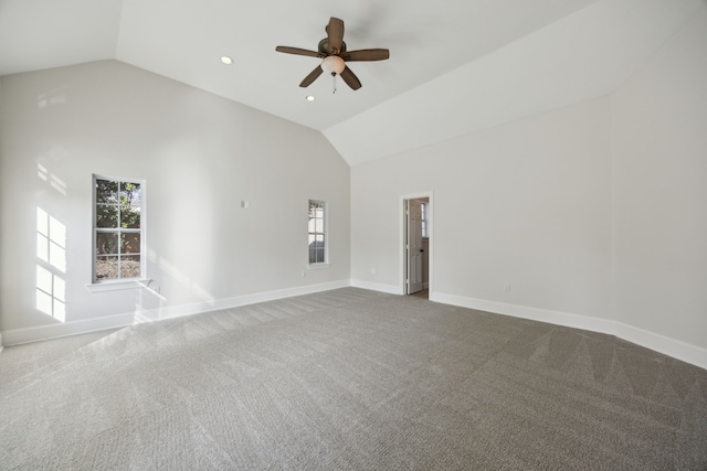 carpeted empty room featuring high vaulted ceiling and ceiling fan