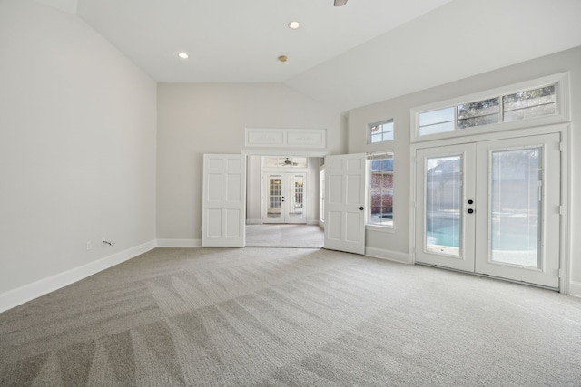 interior space featuring light carpet, lofted ceiling, french doors, and ceiling fan