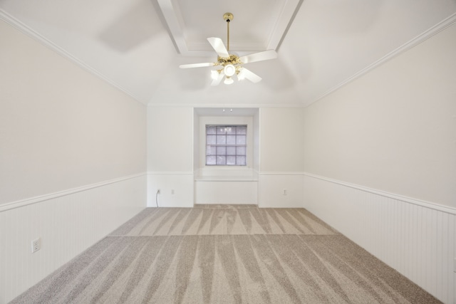 carpeted empty room with crown molding, ceiling fan, and lofted ceiling