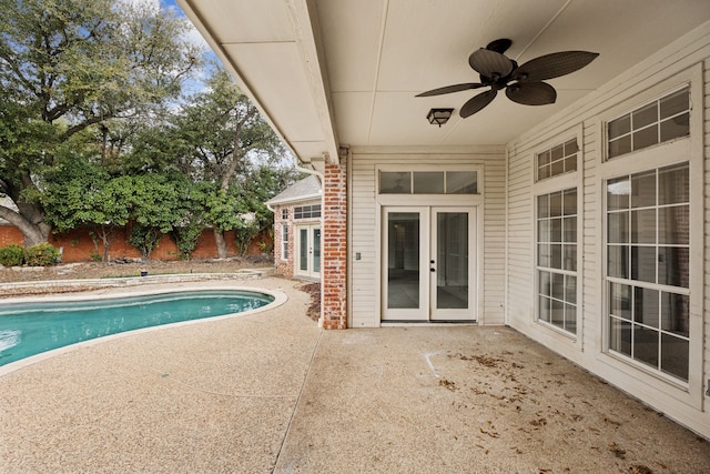 view of swimming pool featuring a patio, french doors, and ceiling fan