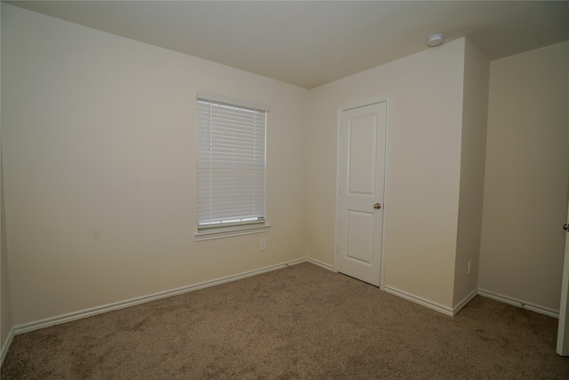 unfurnished room with light colored carpet