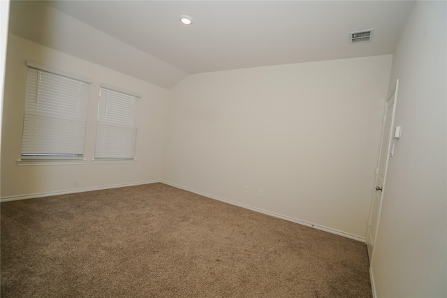 unfurnished room with carpet and lofted ceiling