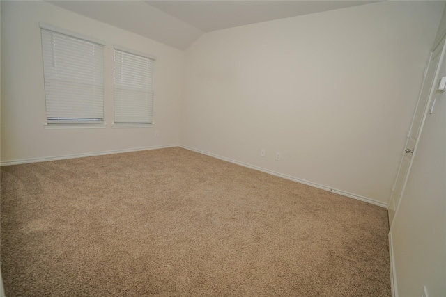 empty room with lofted ceiling and carpet floors