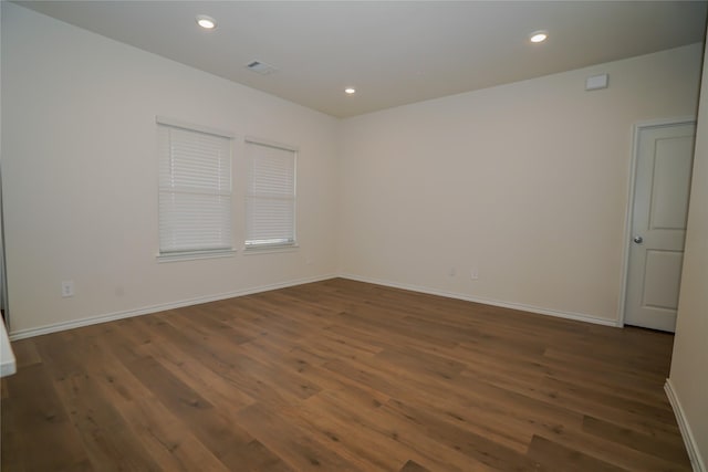 unfurnished room with dark hardwood / wood-style floors