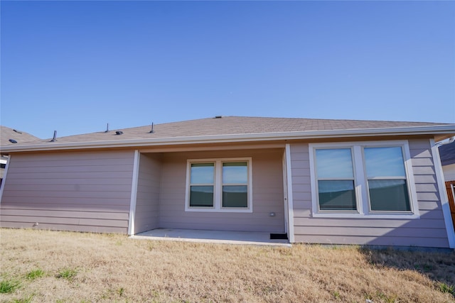 back of property with a patio and a yard