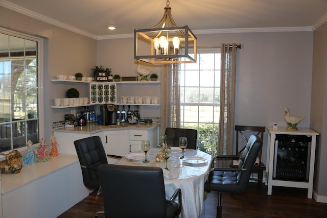 dining room featuring an inviting chandelier, dark wood-type flooring, and ornamental molding