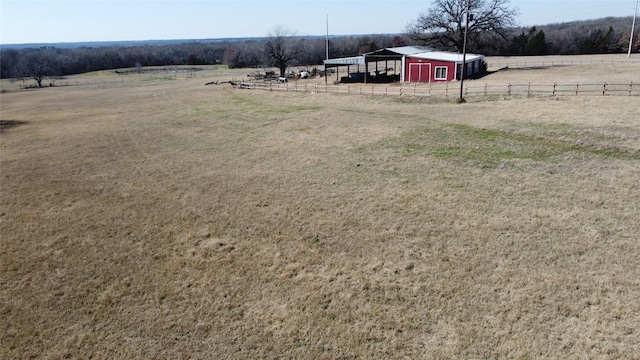 view of yard with a rural view and an outdoor structure