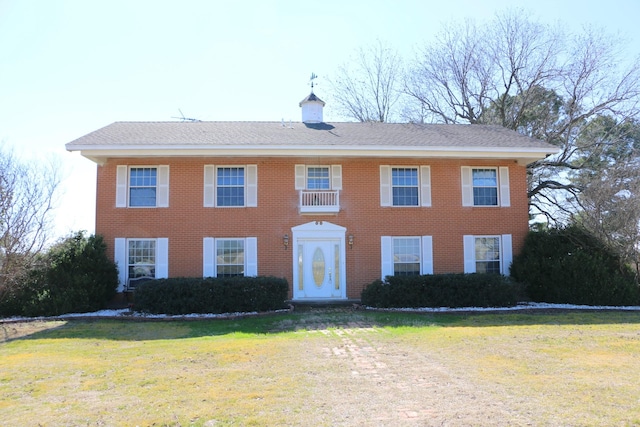 colonial-style house with a front yard