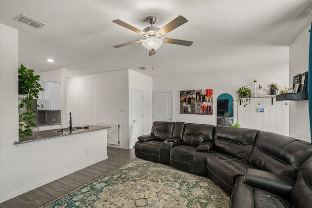 living room with ceiling fan, sink, and dark hardwood / wood-style floors