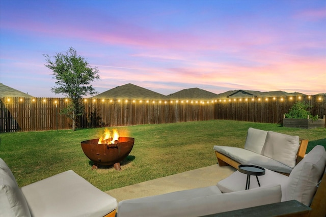 yard at dusk with a fire pit