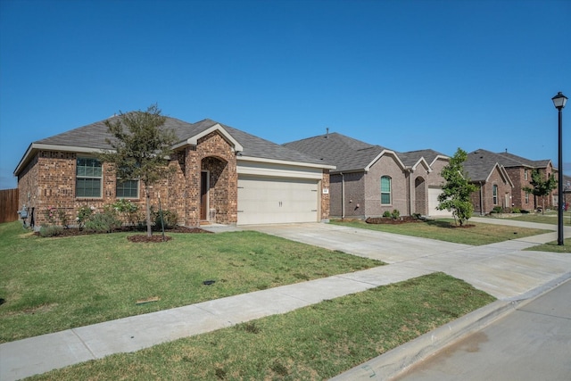 ranch-style house featuring a garage and a front lawn