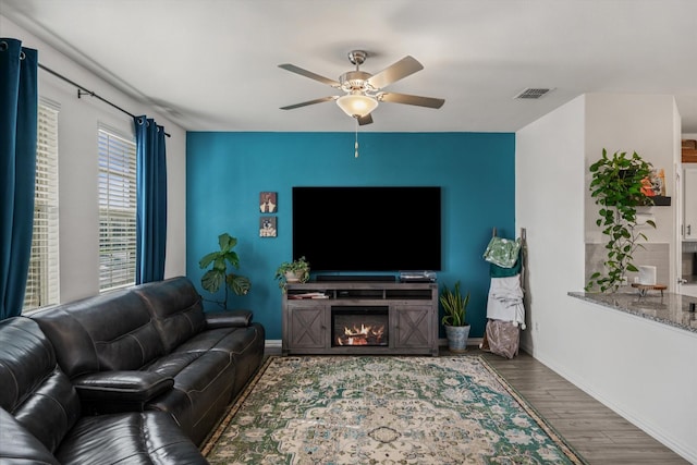 living room with hardwood / wood-style floors and ceiling fan