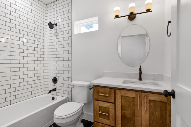 full bathroom featuring vanity, tiled shower / bath combo, and toilet