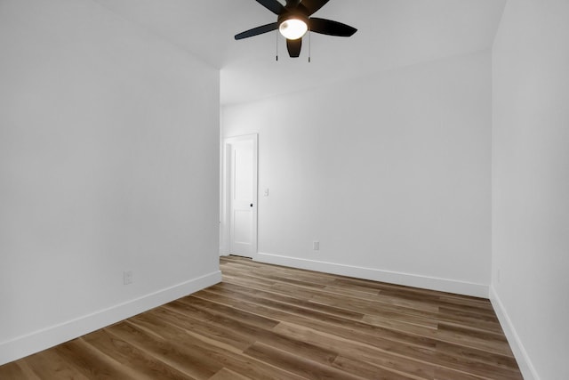 empty room with dark wood-type flooring and ceiling fan