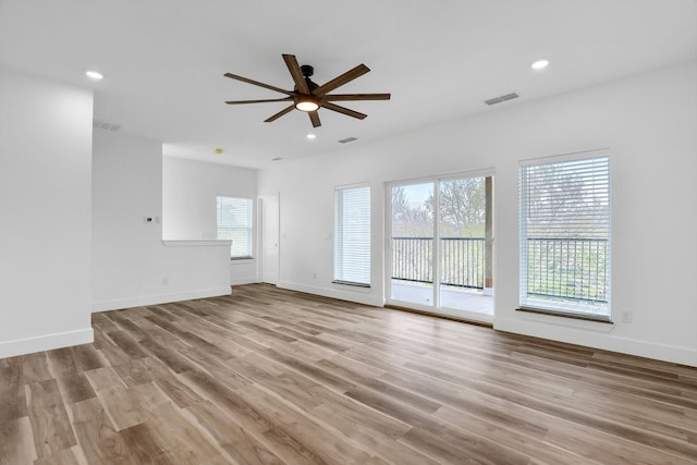 unfurnished living room featuring ceiling fan and light wood-type flooring