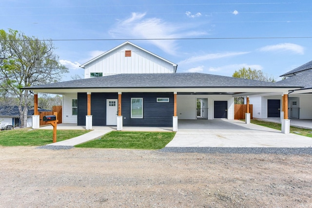 view of front of property featuring a porch, a garage, and a carport