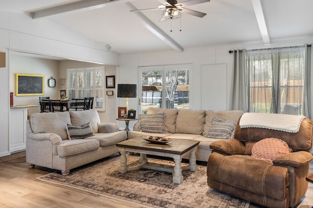 living room with vaulted ceiling with beams, light hardwood / wood-style floors, and ceiling fan