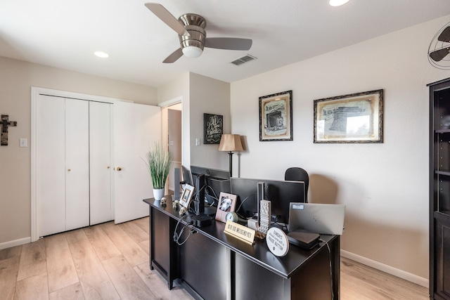 home office with ceiling fan and light hardwood / wood-style floors