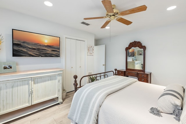 bedroom featuring a closet, ceiling fan, and light hardwood / wood-style flooring