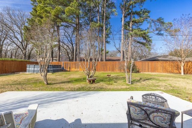 view of yard with a swimming pool, a patio, and an outdoor fire pit