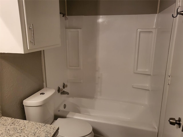 full bath with tub / shower combination, a textured wall, and toilet