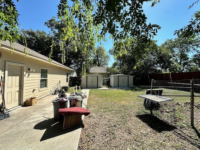 view of yard featuring a storage shed and a patio area