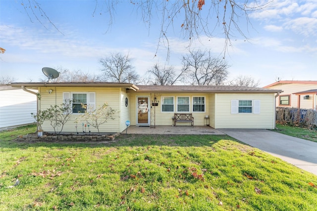 ranch-style house with a patio and a front lawn