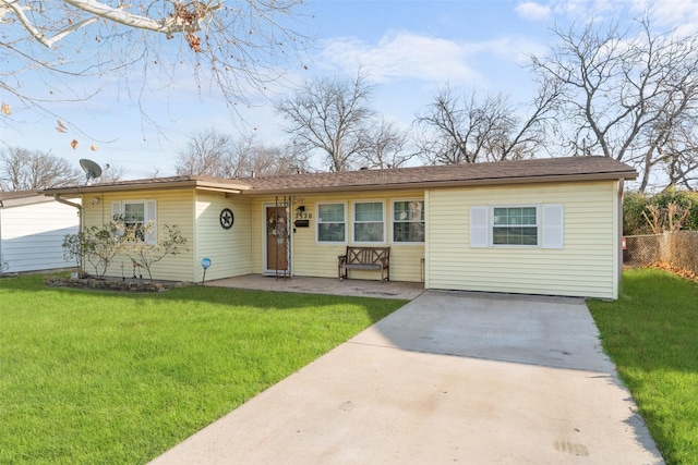 ranch-style home with fence and a front lawn