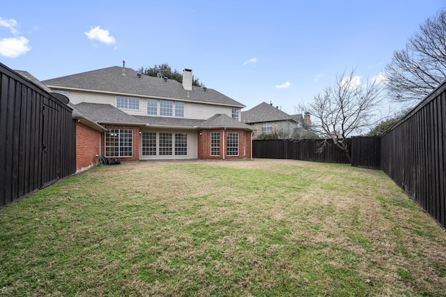 back of house with a yard