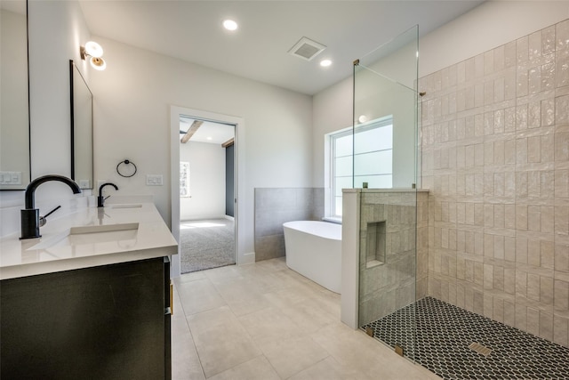 bathroom featuring vanity, tile patterned flooring, and separate shower and tub