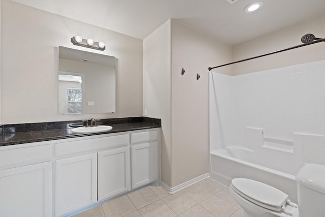 bathroom with toilet, baseboards, tile patterned flooring, vanity, and washtub / shower combination