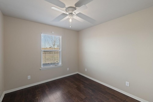 spare room featuring dark wood finished floors, baseboards, and a ceiling fan